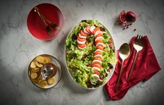 a salad with shrimp and lettuce in a bowl on a marble counter top