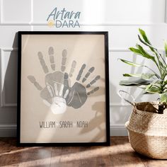 a hand print is displayed in front of a basket with a plant and potted plant