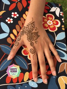 a woman's hand with henna tattoos on it and the words happy henna written