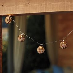 some lights are hanging from a wooden beam