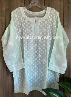 "Soft cotton Chikankari hand embroidered blouse. Matching liner Included. Length: 30 inches Color: Sea Green \"Embroidery designs vary \"" Festive Chikankari Embroidered Straight Kurta Top, Chikankari Embroidered Top For Festivals, Traditional Chikankari Embroidered Top For Festive Occasions, Chikankari Embroidered Top For Eid Festive, Eid Festive Top With Chikankari Embroidery, Festive Chikankari Embroidered Top For Eid, Festive Chikankari Embroidered Top For Navratri, Eid Festive Chikankari Embroidered Top, Semi-stitched Blouse With Chikankari Embroidery For Eid