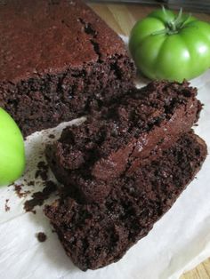 two pieces of chocolate cake with green apples on the side