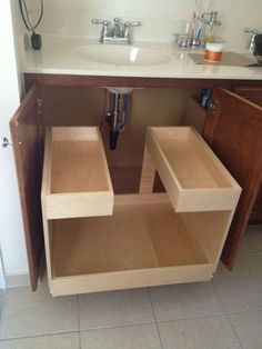 a bathroom sink with two open drawers underneath the faucet in front of it