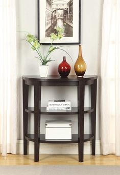 two vases are sitting on a small table