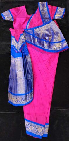 Readymade Bharatanatyam costumes Bring the beauty of Bharatnatyam to life with this ready-made dance costume. Crafted with high-quality fabrics, this costume will provide superior comfort and confidence while you perform. It's the perfect addition to any dancer's wardrobe. Material: Silk Cotton with Kanchipuram Border Size: 34/36/38/40 - Height from Waist to Ankle Bone Age: 14+ Years Traditional Fitted Pre-draped Saree For Navratri, Fitted Traditional Churidar For Navratri, Ceremonial Fitted Choli With Self Design, Ceremonial Fitted Self Design Choli, Fitted Paithani Silk Lehenga In Traditional Drape, Fitted Paithani Silk Lehenga With Traditional Drape, Traditional Blue Cotton Pre-draped Saree, Cotton Silk Churidar For Ceremonial Festivals, Ceremonial Cotton Silk Churidar For Festivals