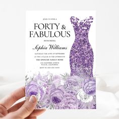 a person holding up a purple and white wedding card that says forty & fabulous on it