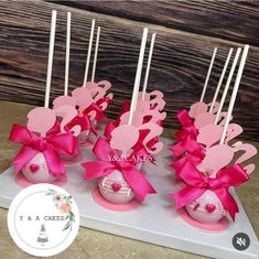 pink cake pops with hearts and bows on them for valentine's day or any special occasion