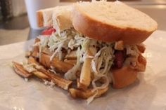 a close up of a sandwich on a plate with french fries