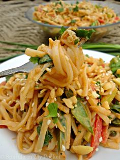 a white plate topped with noodles and vegetables