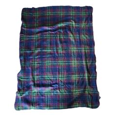 a purple and green plaid blanket on a white background