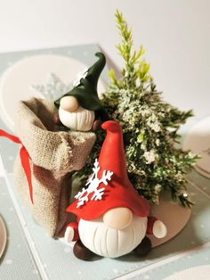 a gnome figurine sitting on top of a table next to a potted plant