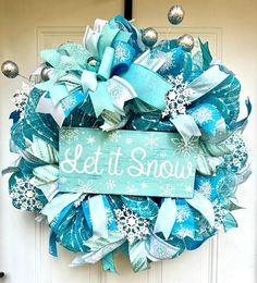 a wreath that says let it snow on the front door