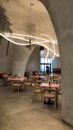 the interior of a restaurant with tables and chairs