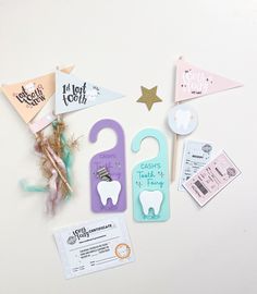 tooth shaped magnets and paper clips on a white surface with other items around them