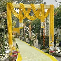 a yellow and white decorated walkway with flowers