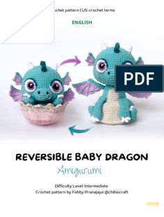 two crocheted baby dragon dolls sitting next to each other on a white background