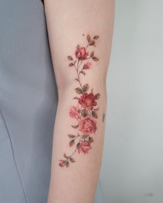 a woman's arm with flowers on it