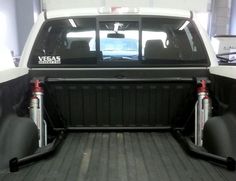 the back end of a white truck with black bed liners