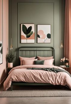 a bedroom with green walls, pink bedding and two paintings on the wall above it