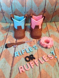 a pair of brown boots sitting on top of a wooden floor next to scissors and rubber letters