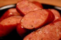 some cooked sausages are in a black bowl