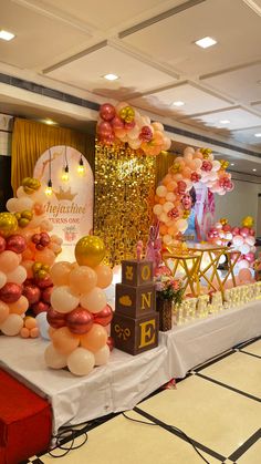 a table topped with lots of balloons and decorations