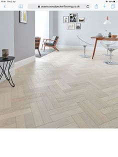 an image of a room with wood flooring on the walls and pictures on the wall