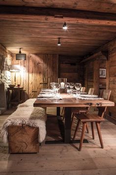 a dining room with wooden walls and flooring