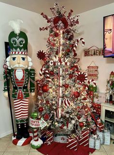 a christmas tree decorated with candy canes and nutcrackers in red, white and green