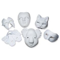 white masks with faces on them are arranged in the shape of an elephant, cat, and giraffe