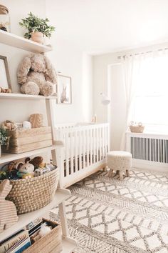 a baby's room with a teddy bear on the wall and toys in baskets