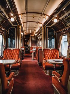 A luxury train with an interior design of a vintage steam train. The train has a wooden and brass interior with plush seats and ornate details. There are also a few tables and chairs. The floor is covered with a red carpet. The lighting is warm and soft. The background contains a door and a window with curtains. Less Vintage Train Carriage, Train Cabin Aesthetic, Steam Train Interior, Train Interior Aesthetic, Train Carriage Interior, Vintage Train Aesthetic, 1800s Train, Train Interior Design, 1920s Train