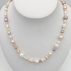 This is a Natural Freshwater Pearl necklace, stud earrings and bracelet set. These perfectly-imperfect baroque pearls are a blend of very light colored pastels, including pink, grey, white and gold. They would make a wonderful addition to your jewelry collection and their neutral tones go with everything. The necklace has a hook clasp in Sterling with a puffed heart charm. The stud earrings are Sterling with rhodium over to prevent tarnish. Elegant Multicolor Jewelry With Pearl Charm, Elegant Multicolor Pearl Charm Jewelry, Formal Pink Baroque Pearl Jewelry, Elegant Multicolor Single Strand Pearl Necklace, Elegant Multicolor Pearl Necklace With Charm, Elegant Multicolor Pearl Necklace For Weddings, Classic Pink Pear Shaped Jewelry, Classic Pink Pear-shaped Jewelry, White Single Strand Pear-shaped Jewelry