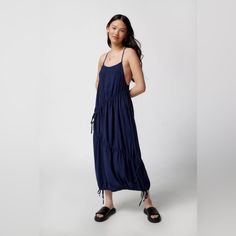 Midi Dress From Uo With Cinched Detailing Through The Bodice And At The Hem. Cut In An Easy Fit With A Lightly Scooped Neckline. Finished With A T-Strap Detail At The Low-Cut Back. Features - Cinched Uo Midi Dress - Relaxed Fit - Adjustable Ties At The Sides + Hem - 100% Polyester Size + Fit - Model In Navy Is 5’8" And Wearing Size Small - Measurements Taken From Size Small - Length: 51" Flowy Maxi Dress With Drawstring, Casual Blue Midi Dress With Tie Back, Summer Midi-length Dress With Drawstring, Blue Ruched Summer Maxi Dress, Blue Ruched Maxi Dress For Summer, Summer Midi Length Dress With Drawstring, Summer Beach Maxi Dress With Drawstring, Summer Maxi Dress With Drawstring For Day Out, Blue Ruched Sundress Maxi Dress