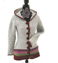 a woman's sweater with a flower on the hood