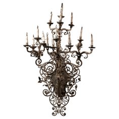 a chandelier with many candles in it on a white background for use as a wall hanging