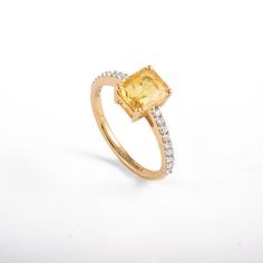 This ring with beautiful Natural Yellow sapphires, is set in 18K Solid Yellow Gold. It is a band ring perfect for any gifting occasions for your loved ones. Purchase the perfect gift for your mom, wife, daughter, girlfriend, and fiancee. This ring, due to its minimalist design, can also be stacked easily with other statement rings. -Material - 18K Solid Yellow Gold -Gemstone - Genuine Yellow Sapphire Diamond -Gemstone weight - 1.830 ct -Diamond Weight - 0.210 Ct -Gross weight - 3.05 grams Yellow Yellow Sapphire Ring With Center Stone In Yellow Gold, Classic Yellow Gold Ring With Yellow Sapphire, Classic Yellow Gold Yellow Sapphire Ring, Classic Yellow Sapphire Yellow Gold Ring, Yellow Sapphire Gemstone Promise Ring, Yellow Sapphire Rings With Halo Setting For Anniversary, Yellow Sapphire Ring In Yellow Gold, Oval Yellow Sapphire Ring With Prong Setting, Anniversary Yellow Sapphire Ring With Halo Setting