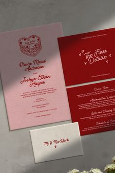 two red and pink wedding cards on top of each other