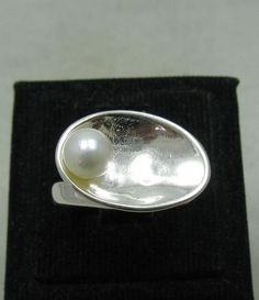 Sterling silver ring 925/1000 with 6mm synthetic pearl. Stamped 925.Approximate weight 4.9 grams. Dimensions 1.3x1.9cm (0.52x0.76 inches). All our jewels are made from solid sterling silver 925/1000 and are carefully crafted by hand in our family workshop. We dispatch your orders in 5 working days, worldwide and the postage is $5. We ship registered priority mail. Please allow 5-7 working days for delivery in Europe and 10-15 working days outside Europe. For any questions - please do not hesitat Sterling Silver Open Ring Pearl Ring For Formal Events, Sterling Silver Open Ring Pearl Ring For Formal Occasions, Sterling Silver Open Pearl Ring With Polished Finish, Sterling Silver Pearl Ring With Polished Finish For Anniversary, Formal Silver Pearl Ring With Polished Finish, Silver Sterling Silver Pearl Ring With Polished Finish, Hallmarked Sterling Silver Oval Pearl Ring, Hallmarked Sterling Silver Pearl Ring, Hallmarked Oval Pearl Ring In Sterling Silver