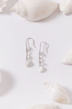 Beautiful freshwater pearls have been set in intricately detailed sterling silver settings and suspended from hook earring backs with a beautiful white topaz leaf design. Beach Shell Pearl Drop Earrings, White Shell Pearl Dangle Earrings, White Shell Dangle Pearl Earrings, Silver Shell Drop Earrings, Beach Shell-shaped Pearl Earrings, Flower Mound