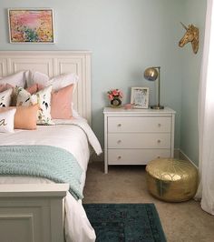 a bed room with a neatly made bed and a night stand next to a window