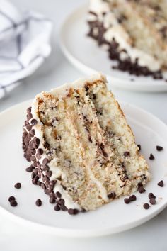 there is a piece of cake on the plate with chocolate chips and cream frosting