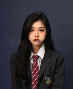 a woman in a suit and tie posing for a photo with her lip sticking out