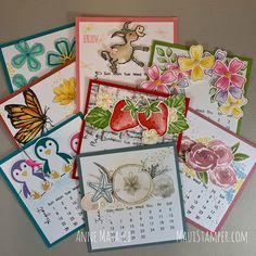 many different cards are stacked on top of each other with flowers and butterflies in them