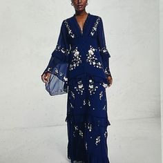 New W/O Price Tag Is An Overstock Outlet (Has Black Line Going Thru Cloth Label Name To Prevent Store Return) Authentic Asos Designs Dress - Tiered Embroidered Maxi Dress - Asos Design Tiered Floral Embroidered Maxi Dress With Raw Edge And Button Detail In Navy - Back Zipper Closure - Upper Tie Closure - Button Down On Front For Show Only; Does Not Work - Blue With Green,White And Pink Embroidered Floral Design - Size Us 6, Uk10; Measures Approx. 17" Flat From Pit To Pit, 29" Waist - Model Bust Embroidered V-neck Georgette Dresses, Embroidered Georgette V-neck Dress, Blue Floral Embroidered Maxi Dress For Evening, Blue Georgette Long Sleeve Maxi Dress, Spring Bohemian Embroidered Evening Dress, Spring Evening Bohemian Embroidered Dress, Blue Embroidered Maxi Dress For Parties, Chic Blue Georgette Dress, Blue Georgette Dresses With Floral Embroidery