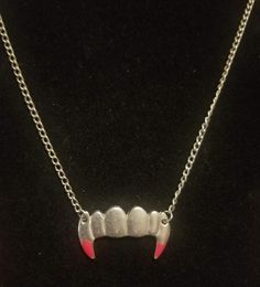 This beautiful necklace is perfect for anyone who loves gothic jewelry! You can have a "fangtastic" time when you add this fang necklace to your jewelry collection or Halloween costume this October! Great for vampire costumes or just sporting your spooky spirit this fright night, each Fang Necklace features a set of sharp chompers accented with some bright red "blood" for the perfect touch. The chain measures 20'' with a lobster clamp and the fangs measure 1 1/2" x 1" **The quarter in the pictur Fang Necklace, Vampire Costumes, Halloween Gothic, Red Blood, Fright Night, Gothic Jewelry, Gothic Fashion, Beautiful Necklaces, Silver Chain