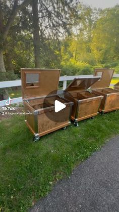 an open wooden box sitting on top of a grass covered field