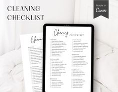 a cleaning checklist sitting on top of a bed next to a tablet computer with the words cleaning checklist written in cursive