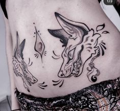 a woman's stomach with an animal tattoo on her belly and the bottom part of her lower back