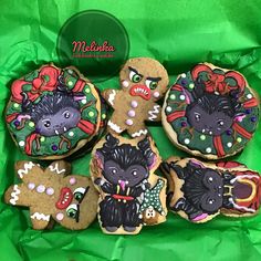 decorated cookies in the shape of animals on green paper